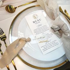 a white plate topped with a menu on top of a gold rimmed place setting