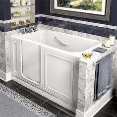 a white bath tub sitting inside of a bathroom