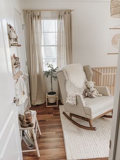 a baby's room with a rocking chair in the corner