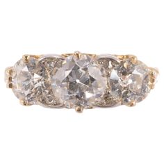 A beautiful and increasingly rare all original antique three-stone diamond ring. The yellow gold ring is fashioned in the "English Carved" motif and features three diamonds approximately H color and VS clarity. The center Old European Cut diamond measures 1.14 carats with matching Old European Cut diamonds weighing 0.58 carats each on either side. Altogether a very special and rare diamond ring in excellent condition. Circa 1890 Rare Diamond Rings, Rare Diamond, Contemporary Engagement Rings, Three Stone Diamond Ring, Carved Ring, 3 Stone Rings, Three Stone Diamond, European Cut Diamonds, Domed Ring