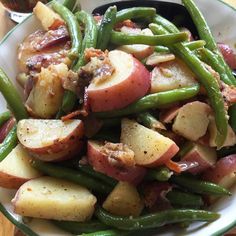 a white plate topped with potatoes and green beans