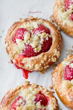 four pastries with strawberries and crumbled toppings