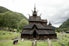 an old wooden church in the middle of a cemetery