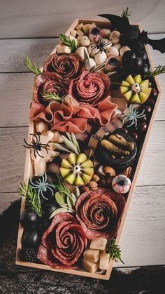 a wooden box filled with lots of different types of food and decorations on top of a table