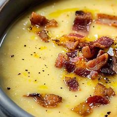 a bowl of soup with bacon and cheese in it