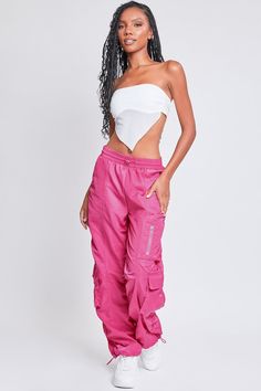 It’s giving off-duty vibes! Our Women's High-Rise Rouched Nylon Jogger is the perfect baggy pant to add to your wardrobe! Designed with an adjustable bungee cord at the elasticized waistband for the perfect fit and comfort. These high waisted pants are meant to be oversized with a baggy and slouchy fit. Featuring silver hardware and large cargo pockets for a sporty-chic vibe. We’ve also added adjustable bungee cords at the bottom hems to give you the option of wearing them more scrunched up at the ankle. Pair these with a crop top and sneakers for a sporty look, or pair with a corset top and combat boots for an edgier feel. Product Details - High-Rise - Elasticized Waistband with Bungee- Single Zip Close Pocket at Thigh- 2 Flap Cargo Pockets at Lower Side - Baggy Fit - Drawstring Hems Size Stretch Nylon Cargo Pants With Drawstring, Pink Nylon Casual Parachute Pants, Pink Parachute Pants With Elastic Waistband For Streetwear, Summer Nylon Parachute Pants With Drawstring, Spring Nylon Cargo Pants With Functional Drawstring, Summer Nylon Parachute Pants With Functional Drawstring, Baggy Nylon Parachute Pants For Spring, Summer Nylon Pants With Functional Drawstring, Baggy Nylon Parachute Pants With Drawstring