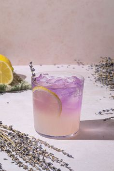 a drink with lavender and lemon on the table