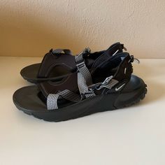 In Excellent Condition, Has Small White Stains, Not To Noticeable. Bottoms Look Brand New Black Slip-on Sport Sandals For Outdoor Activities, Black Slip-on Sport Sandals For Hiking, Comfortable Black Slip-on Sport Sandals, Black Sporty Hiking Sandals, Comfortable Synthetic Sport Sandals With Round Toe, Flat Sandals With Branded Insole For Outdoor, Comfortable Round Toe Synthetic Sport Sandals, Black Closed Toe Hiking Sandals, Synthetic Slip-on Sandals For Walking