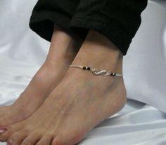 Infinity black onyx ankle bracelet, Eternity anklet, Black stone ankle bracelet This listing is for an elegant infinity charm and black onyx gemstone ankle bracelet. It comprises a silver plated infinity connector, silver plated round beads and faceted black onyx gemstones on silver plated chain. The anklet closes with a silver plated lobster clasp and has a small extender chain attached. Anklet length - 23cm (9 inches)  with 1 inch extender - Custom length available upon request. The anklet com Elegant Handmade Sterling Silver Anklets, Elegant Flexible Anklets As Gift, Elegant Flexible Anklets For Gifts, Elegant Handmade Infinity Jewelry, Elegant Hypoallergenic Anklets For Gifts, Elegant Flexible Silver Anklets, Adjustable Black Nickel-free Body Jewelry, Elegant Adjustable Sterling Silver Anklets, Leg Thread Anklet Black