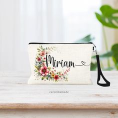 Looking for a gift for your best friend? The Floral Name make up bag is a stylish and versatile linen wristlet, perfect for storing your cosmetics and other essentials. With a convenient zipper pouch, it is the ideal accessory for on-the-go beauty, money & more. Personalize yours and make it truly unique! Don't forget to add on a matching coin purse! DETAILS: ➤ Designs are professional printed using high quality inks to prevent fading, cracking or peeling. ➤ Large Bag is Approximately 8.75" x 6" ➤ Coin Purse is Approximately 6" x 4" (No Strap) ➤ Material: Poly Linen Bag with black zipper & Black wristlet. No lining on the inside. ➤ Design can be printed on one side or both. You Choose! ➤ Black wristlet included! ➤Washable. lay flat to air dry. ➤ All of our items are designed & handmade by Gift Wristlet With Zipper Pouch, Zipper Pouch Wristlet For Gift, Zipper Pouch Wristlet As Gift, Wristlet Zipper Pouch As Gift, Beige Pouch Wristlet For Gift, Beige Pouch Wristlet As Gift, Personalized Makeup Bag, Personalized Makeup Bags, Black Wristlet