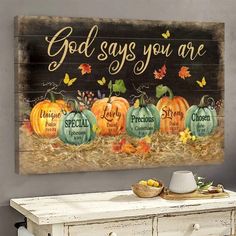 a wooden sign that says god says you are surrounded by pumpkins