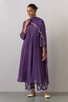 Purple placement embroidered kurta with a round neckline and long sleeves. Paired with a scalloped hem pant and tissue organza dupatta.
Components: 3
Pattern: Embroidered
Type Of Work: Thread
Neckline: Round
Sleeve Type: Three-quarter
Fabric: Chanderi, Tissue Organza
Color: Purple
Other Details: 
Note: Inner worn by the model is not for sale
Occasion: Puja - Aza Fashions Diwali 2024, डिजाइनर कपड़े, Kameez Designs, Kurta Pant Set, Simple Kurta Designs, Women Kurta, A Line Kurta, Dress Design Patterns, Kurta Designs Women