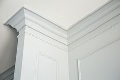 the corner of a room with white walls and trimmings on it's edges