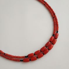 < Red coral necklace with black glass seed beads > The product is made according to the model of authentic Ukrainian jewelry. The coral is natural, from the bottom of the Pacific Ocean, > Necklace lenght: the first string - 39 cm (15,3 in) > Necklace weight - 15 gm Traditional Double Strand Beaded Necklace For Gift, Traditional Double Strand Necklace As A Gift, Handmade Red Beaded Necklaces With Oval Beads, Red Double Strand Beaded Necklace With Polished Beads, Traditional Double Strand Beaded Necklaces For Gifts, Red Coral Beaded Necklace With Spacer Beads, Traditional Handmade Double Strand Beaded Necklaces, Traditional Double Strand Beads For Gift, Traditional Handmade Double Strand Beaded Necklace