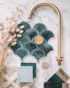 the bathroom is decorated with blue and gold fixtures, including a brass faucet