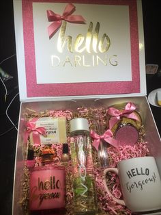 the hello darling gift box is filled with personal items and has pink bows on it