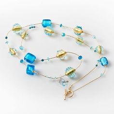 "Length: 88 cm / 34,64 \" Weight: 100 gr / 0,22 lb Classic tradition of this necklace is captured by the unique beads of different shapes: a succession of aquamarine glass squared and rounded beads, covered by precious gold leaf and \"sommerso\" in crystal, alternating with small spheres. The modern touch is given by the small crystals framing each bead, giving them additional light. This necklace, with its bright colours, is perfect for any style and fashion: its light composition makes it the Long Glass Beaded Chain Necklace, Elegant Turquoise Long Necklace For Gift, Blue Long Necklace For Gift, Glass Beaded Chain Long Necklace, Beaded Glass Long Necklace As A Gift, Long Czech Glass Necklace, Handmade Glass Long Necklace For Gift, Glass Spacer Beads Necklace As Gift, Long Glass Beaded Necklace As Gift