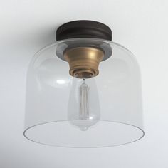 a light fixture with a clear glass dome on the top and a metal cap on the bottom