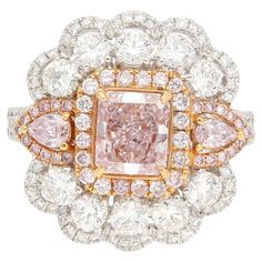 a fancy pink diamond surrounded by white and yellow diamonds