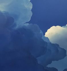 an airplane is flying through the clouds in the blue sky with some white fluffy clouds