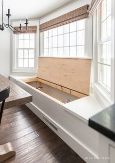 an empty room with a wooden bench in the middle