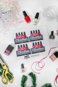 various nail polish and christmas decorations on a white surface with scissors, sprinkles, confetti