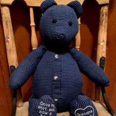 a blue teddy bear sitting on top of a wooden chair