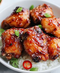 a white bowl filled with chicken wings and rice