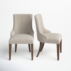 two upholstered chairs side by side on a white background, one is beige and the other is brown