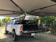 the truck is parked under an awning