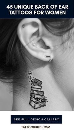 the back of a woman's neck with tattoos on it and an ear piercing