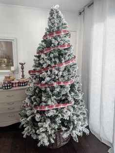 a christmas tree with red and white ribbons