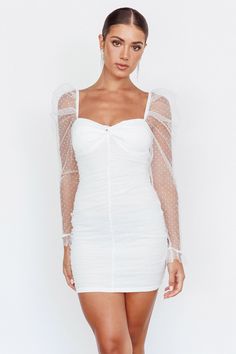 White mini dress Lined Padded bust Boning in the bodice Hail spot mesh fabric Sheer, long sleeves Ruched body Zipper in back Sweep them off their feet in our gorgeous Like Lovers mini dress. Featuring a delicate hail spot throughout and sheer sleeves. It's perfect for graduation or a bridal shower! Team it with tie-up, white heels and a clutch for an unforgettable look. MODEL INFO Model is wearing size XS Height: 5'6" Bust: 32" Waist: 24.5" Hips: 34.5" CARE Hand Wash Cold. Do Not Iron. MATERIAL Leslie White, Selfie Leslie, Yellow Bridesmaids, White Bride, Mini Dress White, Mini Dress Fashion, Blue Bridesmaids, White Heels, Clothing Tags