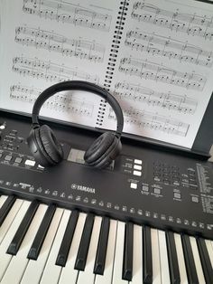 headphones sitting on top of an electronic keyboard