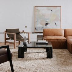 a living room filled with furniture and a painting