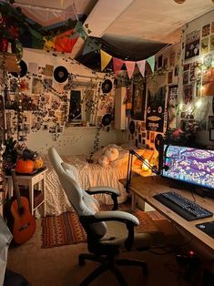 a computer desk with a monitor and keyboard on it in a room filled with decorations