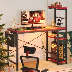 a computer desk sitting next to a christmas tree