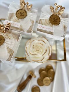 gold and white wedding favors are on display