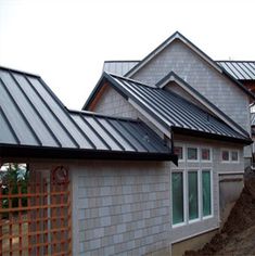 a row of houses with metal roofing on the top and side of each house