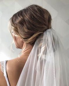 the back of a woman's head wearing a wedding veil