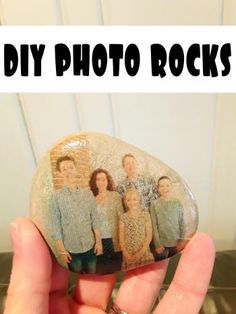 a person holding up a rock with the words diy photo rocks on it