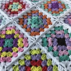 a crocheted blanket with multicolored squares on it