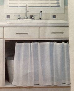 a bathroom with a sink, mirror and white shower curtain in front of the vanity