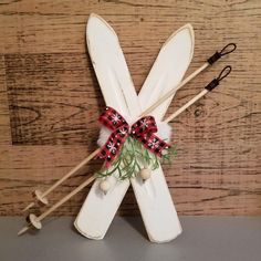 two white skis with red and black bows on them sitting next to each other