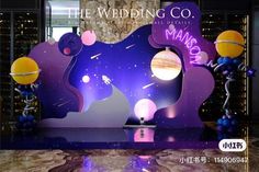 an image of a wedding stage set up with balloons and space theme on the backdrop