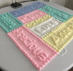 a crocheted blanket sitting on top of a table