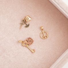 Faith, Hope & Love: Cross, Anchor & Heart · 14k yellow gold· 13 x 9mm (without bail) Peace sign:· 14k yellow gold· 13 x 10mm (without bail) Padlock & key:· 10k yellow & rose gold· 21 x 15mm (without bail) Anchor Heart, Party Icon, Chevron Earrings, Chevron Bracelet, Chevron Necklace, Chevron Ring, Gold Charms, Faith Hope Love, Moonstone Necklace