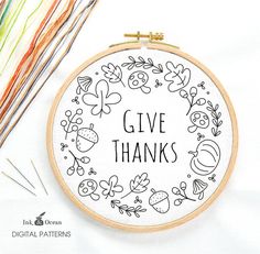 a cross stitch pattern with the words give thanks in black and white, surrounded by knitting needles