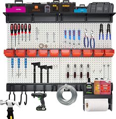 a wall mounted tool rack with various tools on it