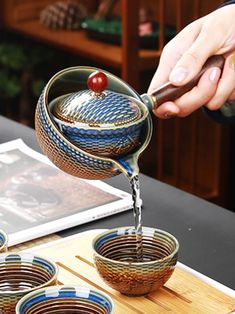 a person pours water into small bowls